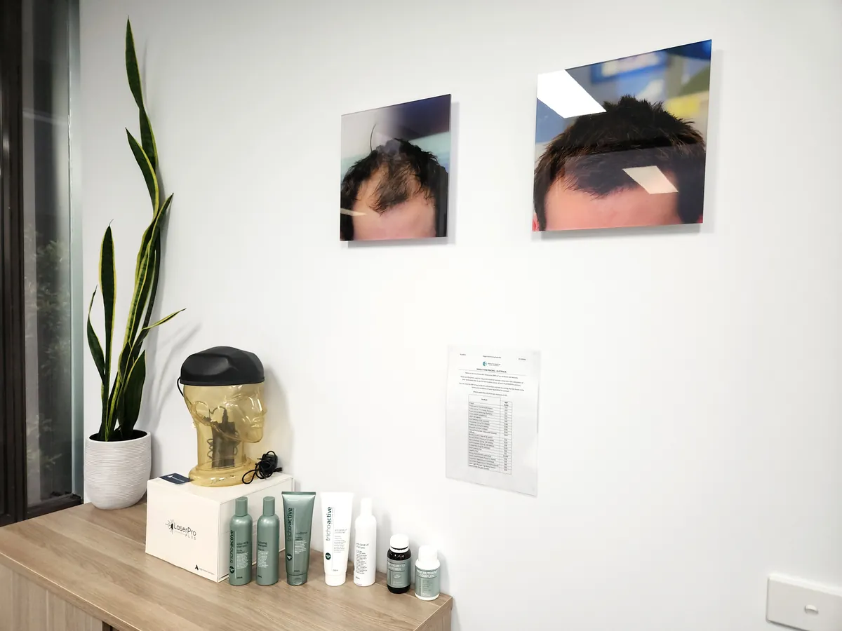 Retail products display on credenza with before-and-after photos at the Ashley & Martin cosmetic clinic fitout, Southbank.