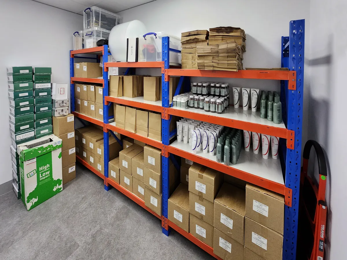 Storeroom with pallet racking holding stock boxes and product at the Ashley & Martin cosmetic clinic fitout, Southbank.