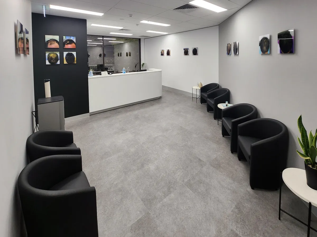 Waiting area with tub chairs facing reception and feature wall at the Ashley & Martin cosmetic clinic fitout, Southbank.