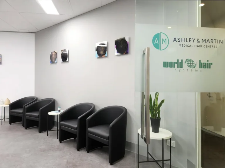 Waiting area with black tub chairs and branded glazed signage at the Ashley & Martin cosmetic clinic fitout, Southbank.
