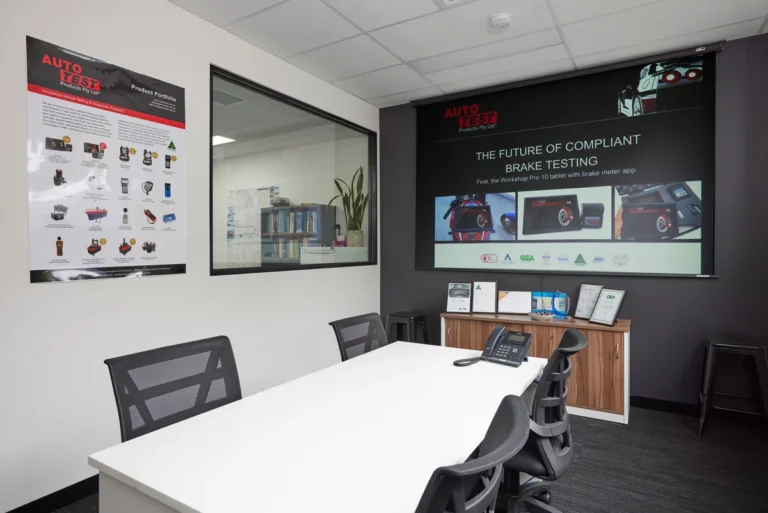 Meeting room with table, chairs and projector screen, Autotest warehouse-to-office conversion, Kensington.