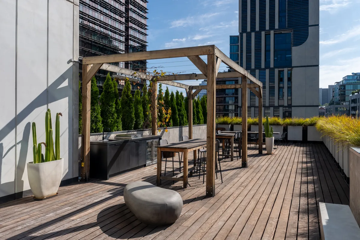 Rooftop terrace with timber pergola and high tables, Clinibase office fitout, Collingwood.