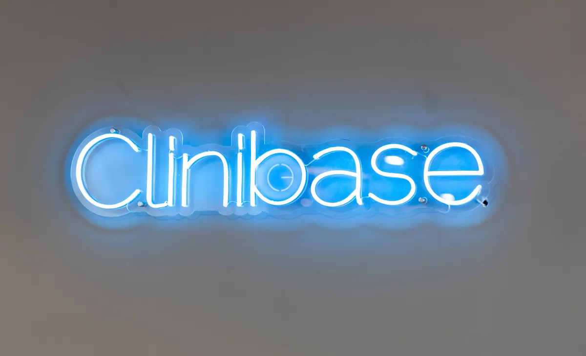 Blue neon Clinibase signage mounted on a feature wall, Clinibase office fitout, Collingwood.