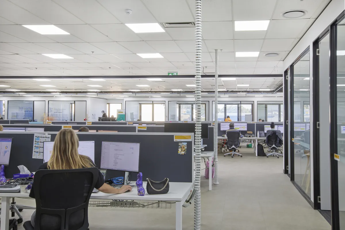 Staff at open-plan workstations with glass partitions at the CPB Contractors office fitout, Blackburn North.
