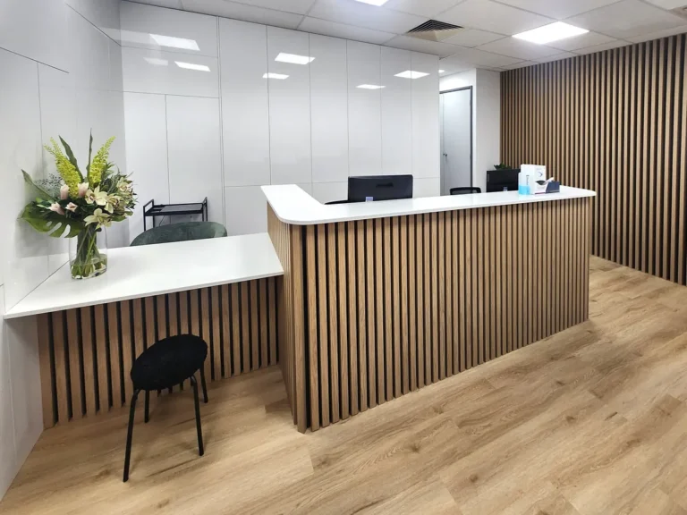 Timber batten reception desk and front counter at the Creative Smiles dental clinic fitout, Armadale.