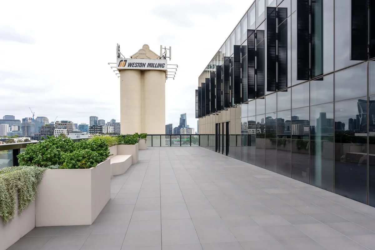 Exterior terrace and glazed facade with Melbourne skyline at the Empower Wealth office fitout, North Melbourne.