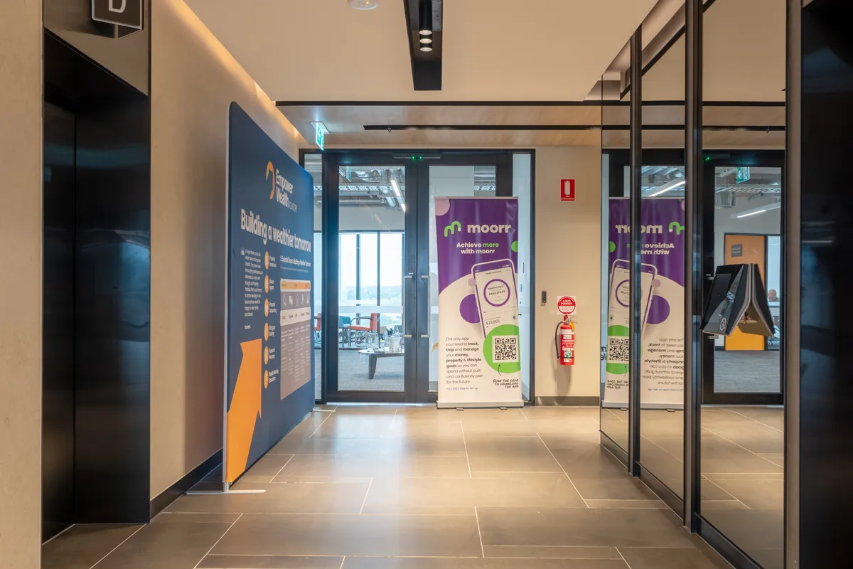 Entry lobby with Empower Wealth and Moorr branded signage and lifts at the office fitout, North Melbourne.