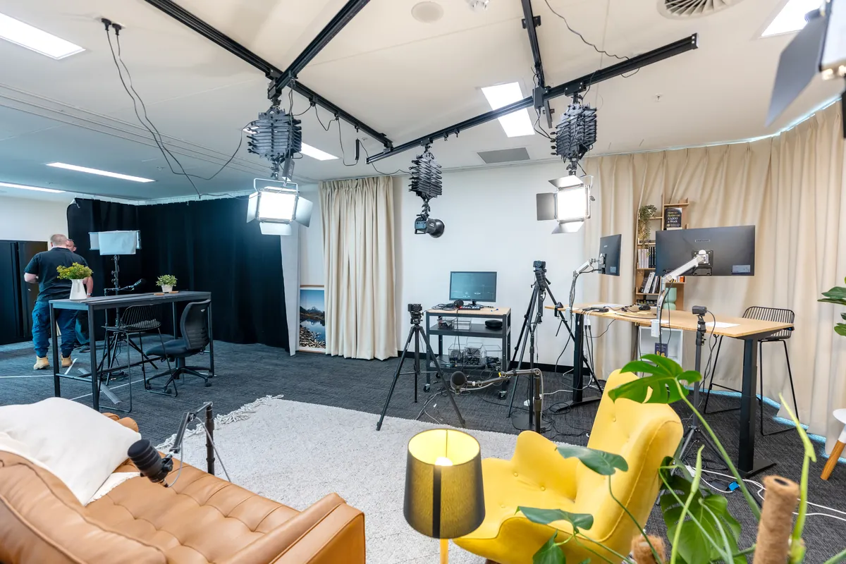 Podcast studio with lighting truss, recording desks and acoustic curtains at the Empower Wealth office fitout, North Melbourne.