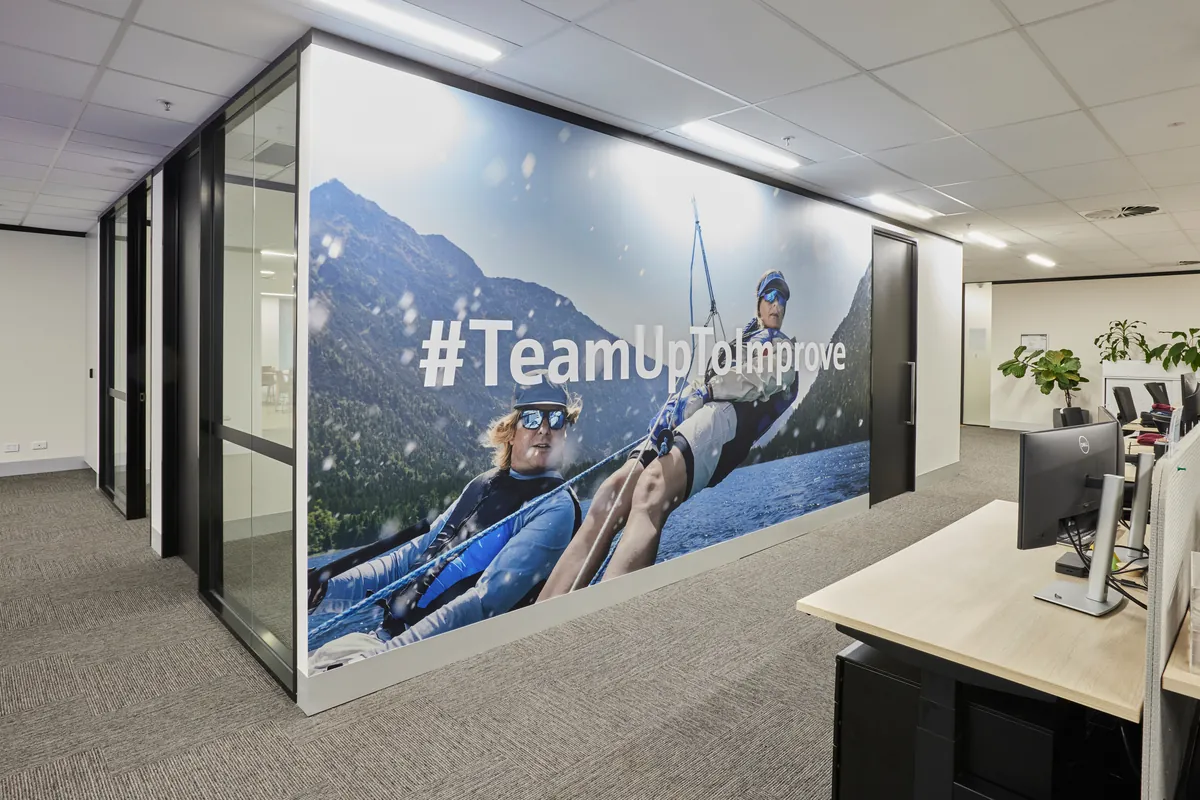 Open-plan workspace with branded feature wall at the Endress and Hauser office fitout, Mulgrave.