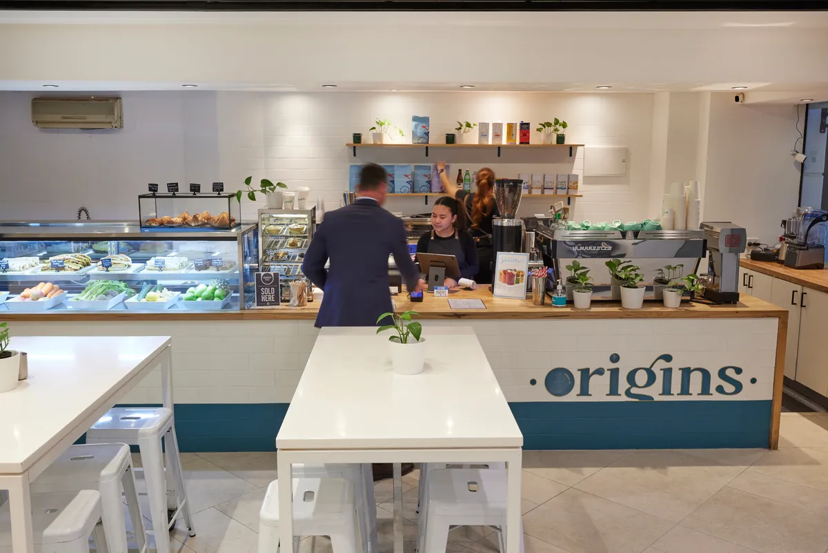 Origins cafe service counter with food display and barista station at the Exchange Tower refurbishment, Melbourne.