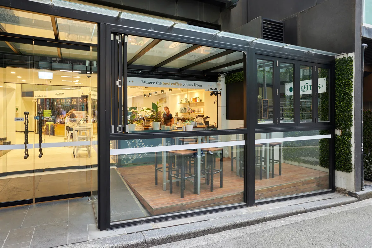 Origins cafe shopfront with bi-fold glazing and timber deck at the Exchange Tower office refurbishment, Melbourne.