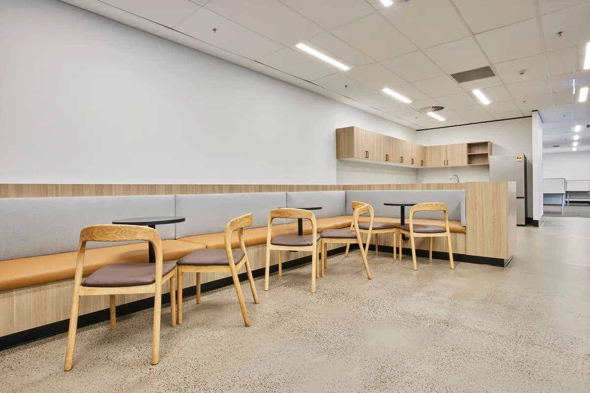 Breakout banquette seating with timber kitchenette joinery, Growthpoint spec suite fitout, Mulgrave.