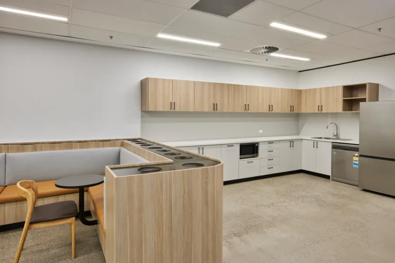 Kitchen with curved timber banquette and full appliances, Growthpoint spec suite fitout, Mulgrave.