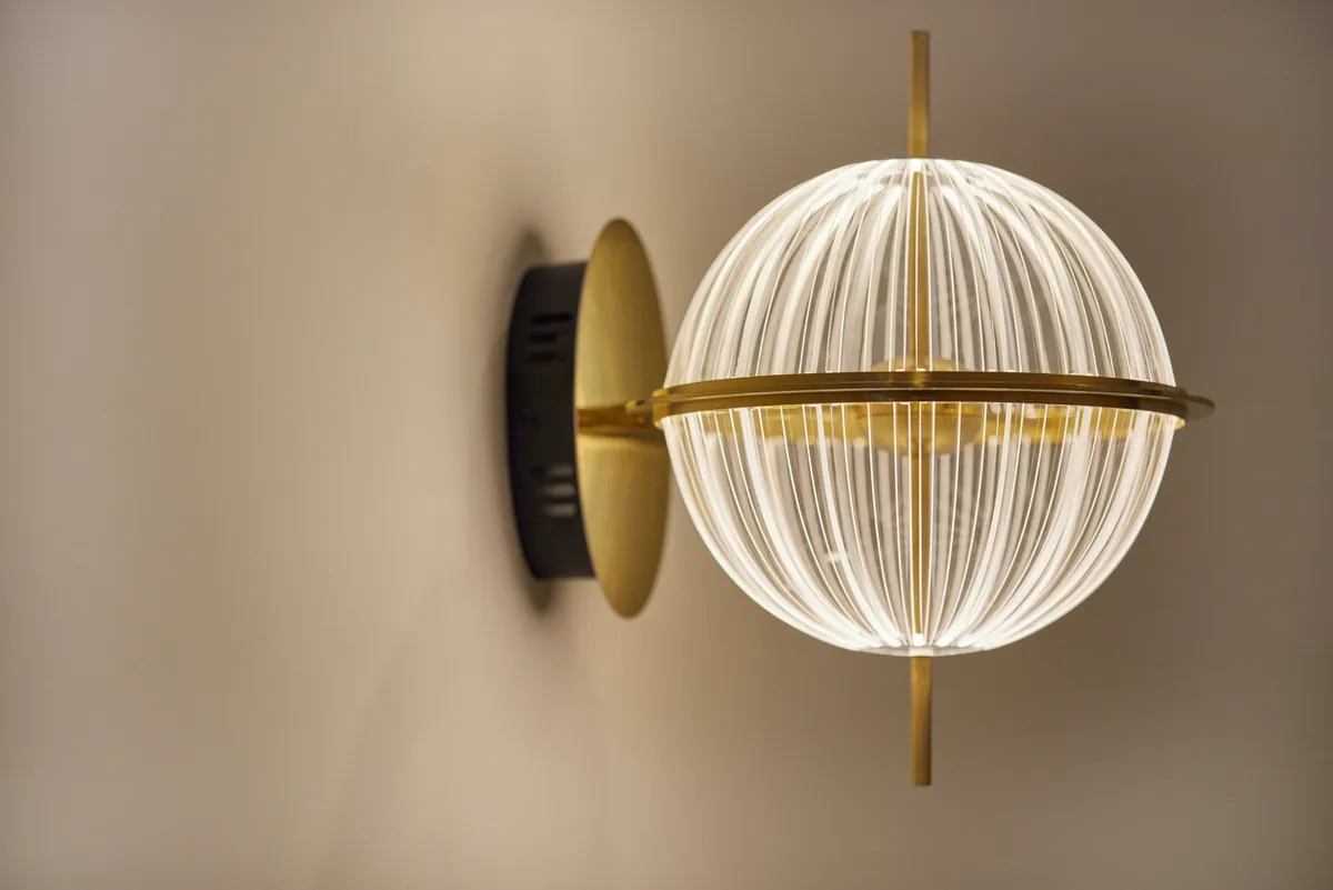Brass and glass globe wall sconce detail at the Kew Periodontics dental clinic fitout, Kew.