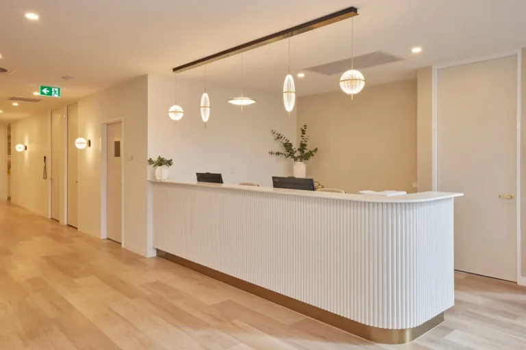 Reception desk and corridor entry at the Kew Periodontics dental clinic fitout, Kew.