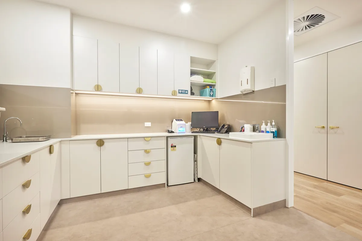 Sterilisation bay with sink and storage joinery at the Kew Periodontics dental clinic fitout, Kew.