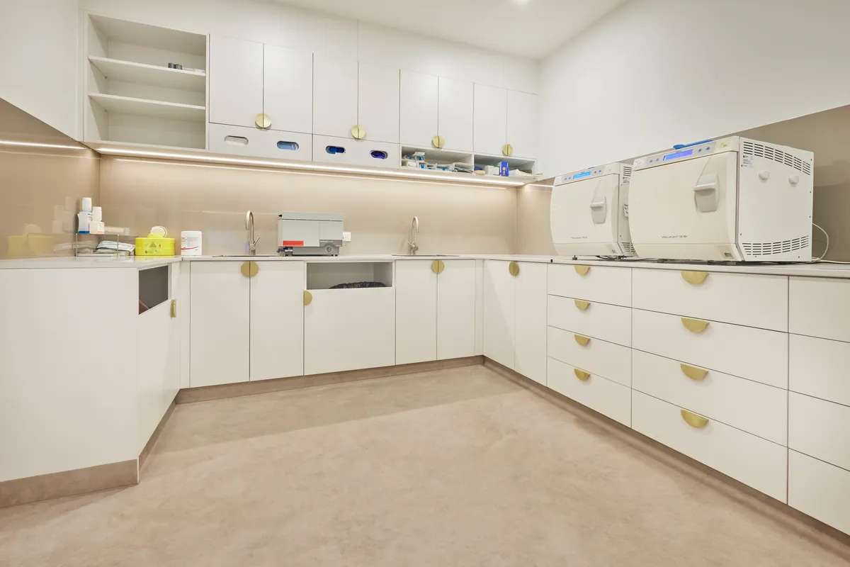 Sterilisation room with autoclaves and custom joinery at the Kew Periodontics dental clinic fitout, Kew.