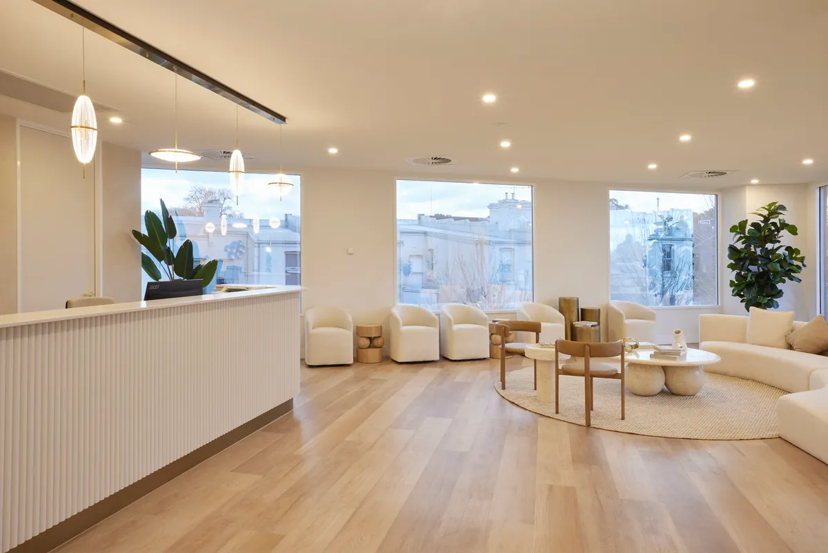 Waiting lounge with armchairs and city views at the Kew Periodontics dental clinic fitout, Kew.