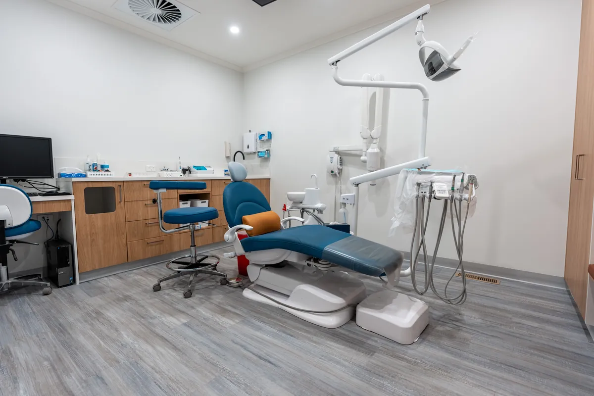 Dental surgery with blue treatment chair and joinery at the Kyneton Dental dental clinic fitout, Kyneton.