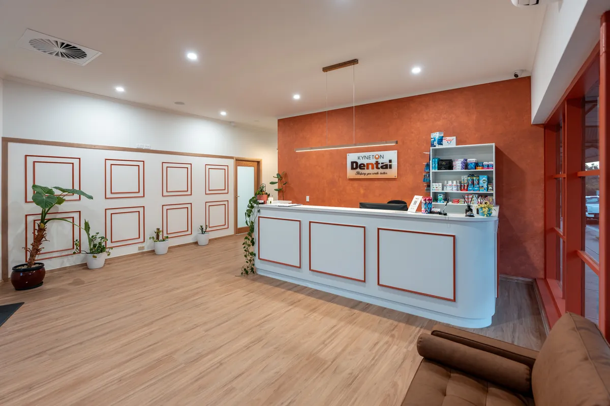 Custom reception desk with feature wall and signage at the Kyneton Dental dental clinic fitout, Kyneton.