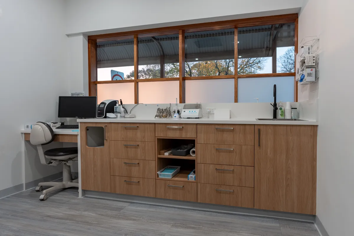 Treatment room with custom joinery workbench and instrument storage at the Kyneton Dental dental clinic fitout, Kyneton.