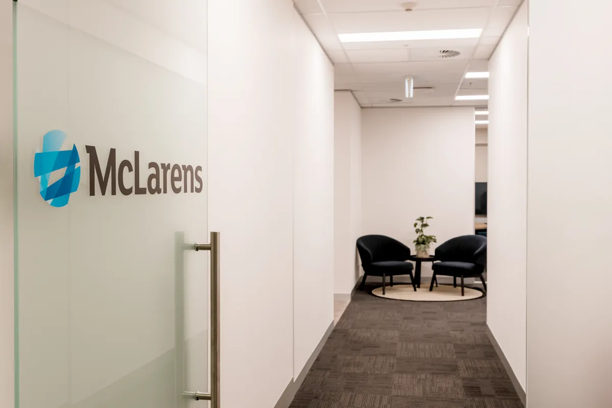 Branded glass entry and reception waiting area at the McLarens office fitout, Melbourne.