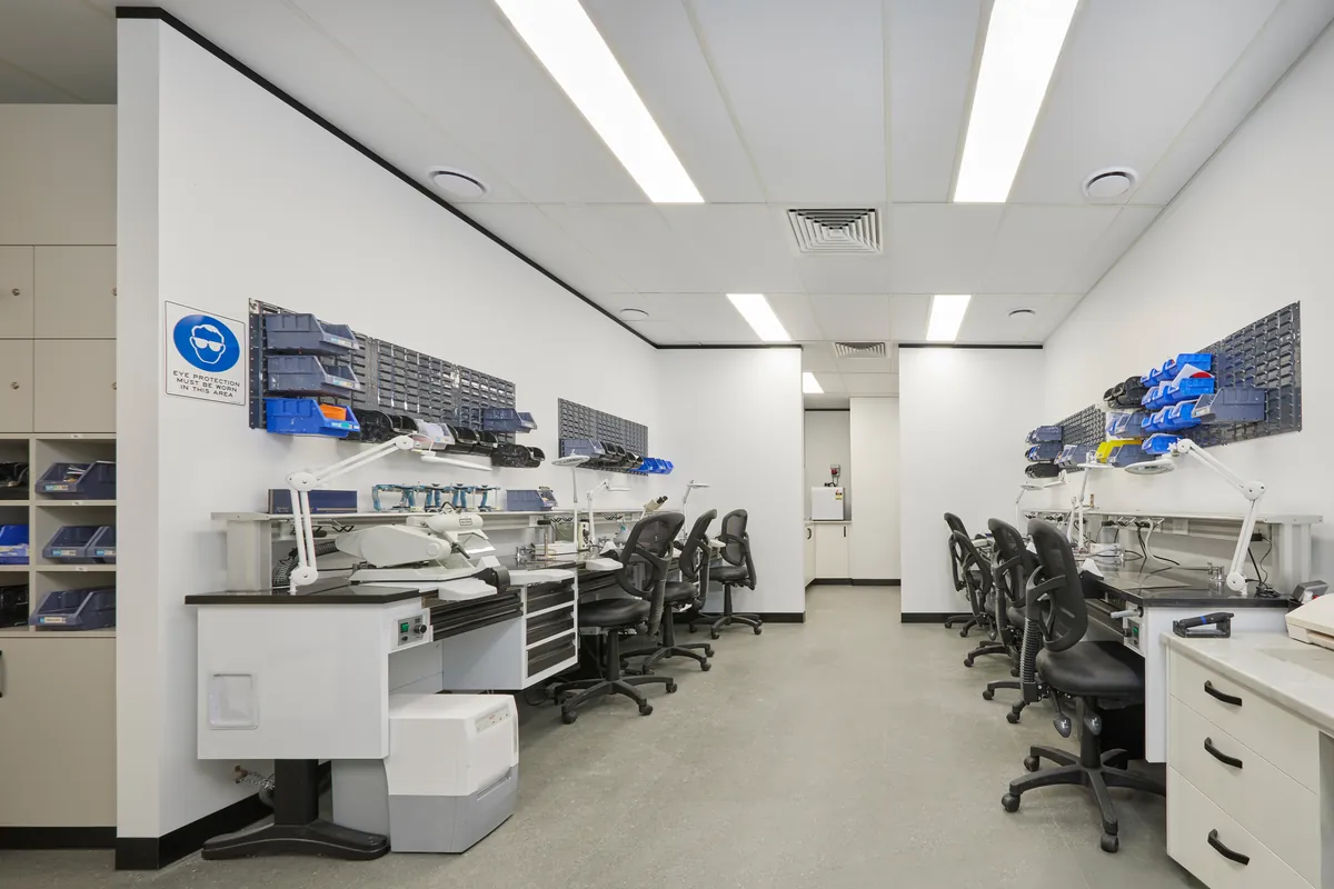 Dental technician benches with task lighting in the Melbourne Smiles dental clinic fitout, North Caulfield.