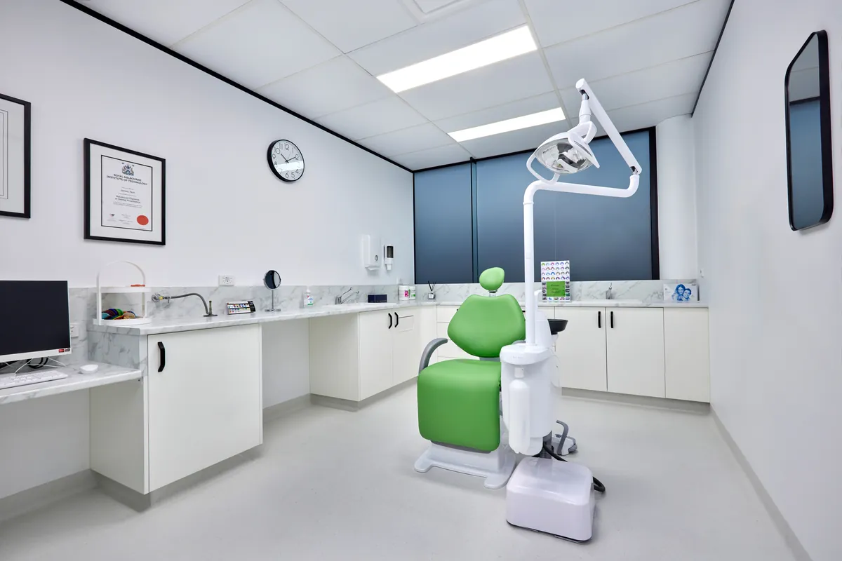 Dental surgery with chair and operatory light on marble benchtop, Melbourne Smiles dental clinic fitout, North Caulfield.