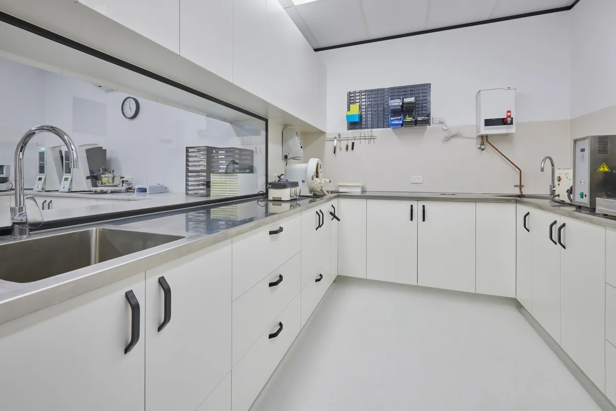 Sterilisation room with stainless steel sink and tool rack, Melbourne Smiles dental clinic fitout, North Caulfield.