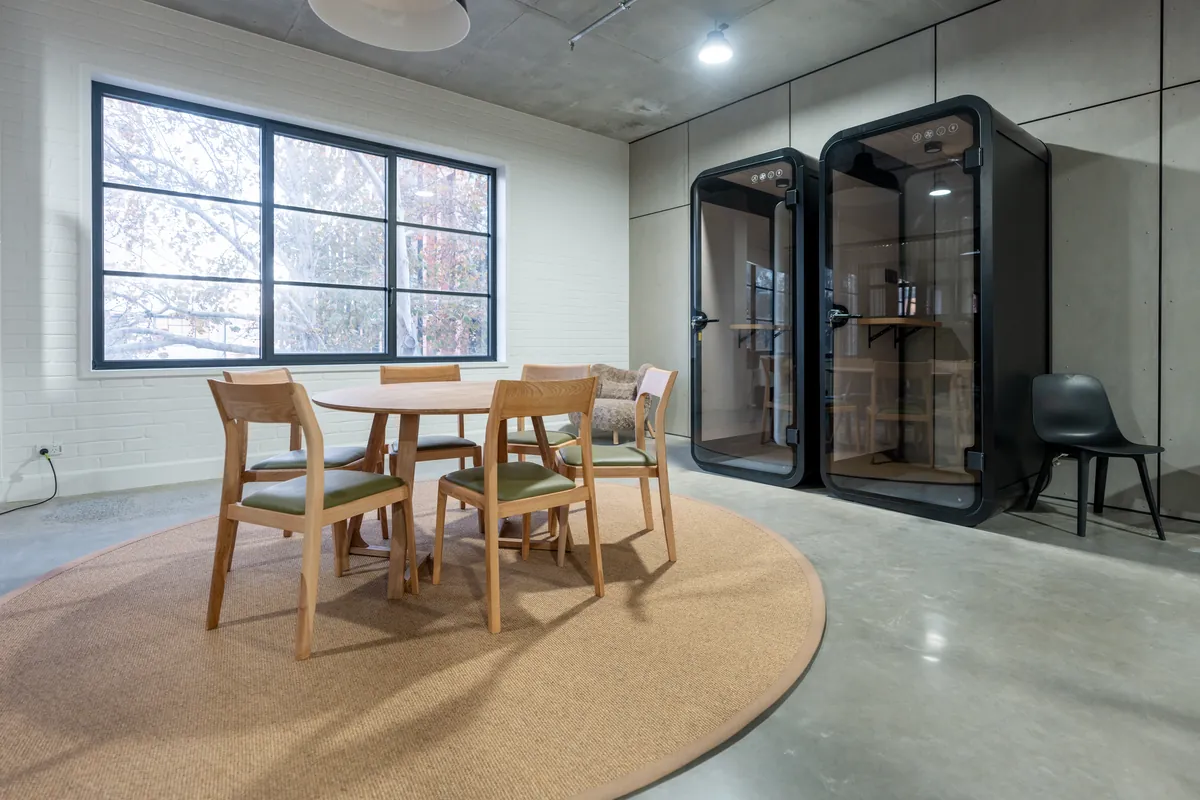 Acoustic phone booth pods beside a breakout table at the Resilience Project office fitout, Collingwood.