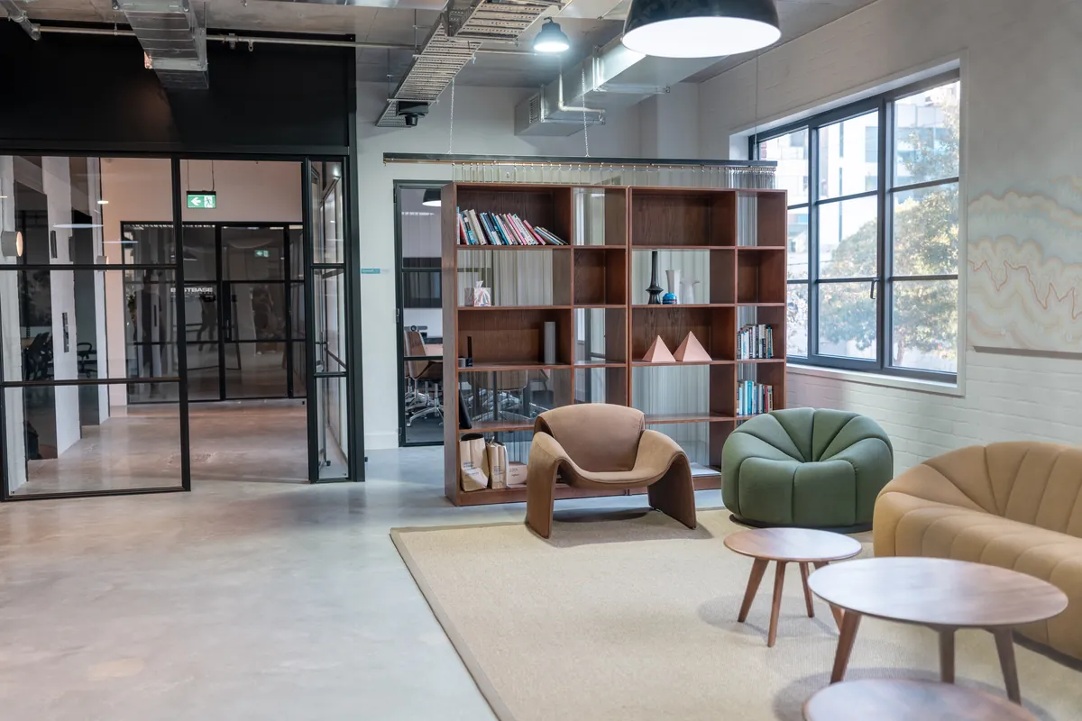 Breakout lounge with shelving room divider and glass partitioning, Resilience Project office fitout, Collingwood.