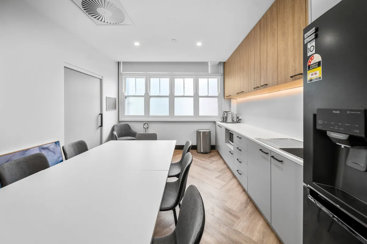 Staff breakout kitchen with dining table at the SleepWise Clinic dental clinic fitout, Melbourne.