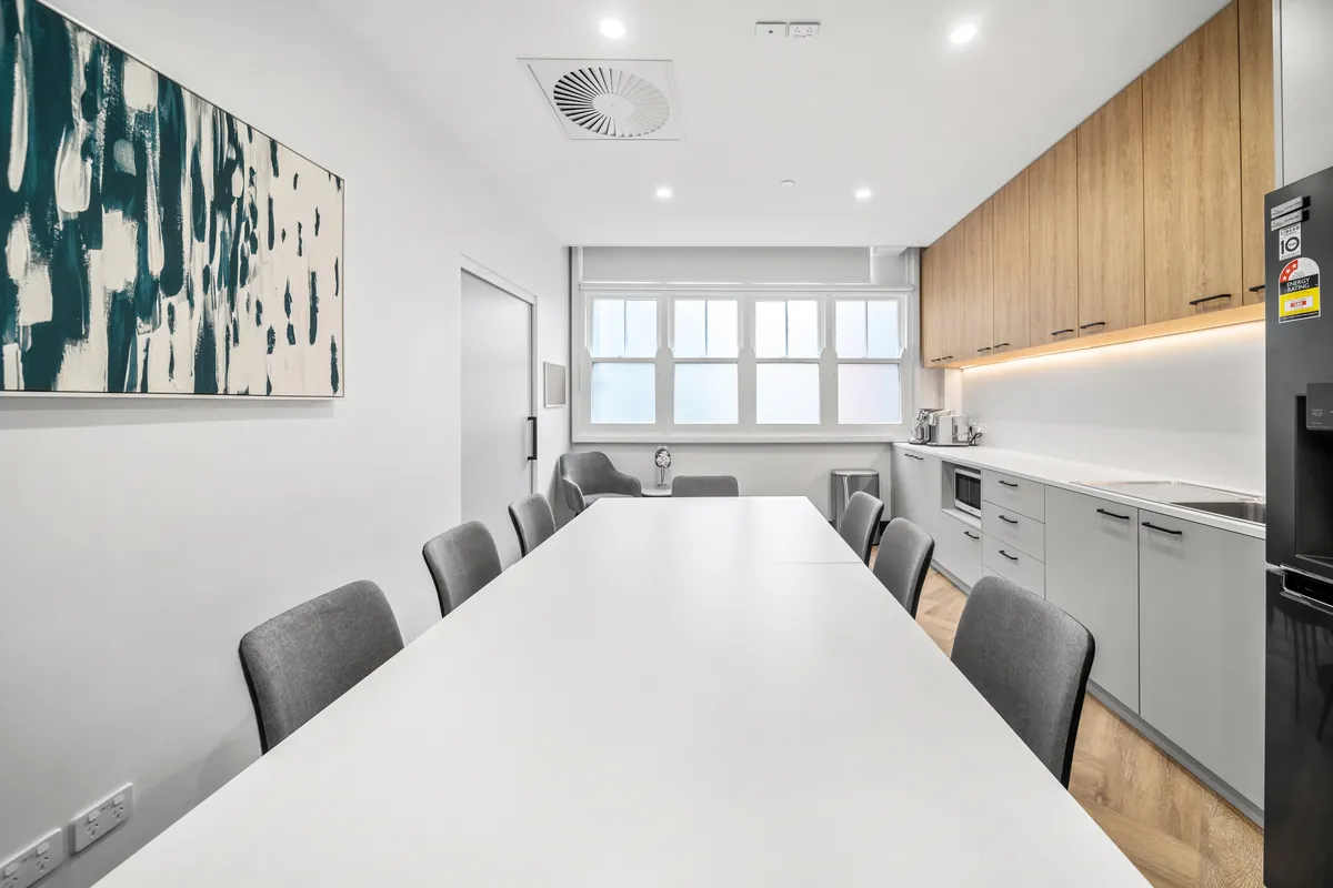 Staff breakout room with feature artwork and kitchenette at the SleepWise Clinic dental clinic fitout, Melbourne.