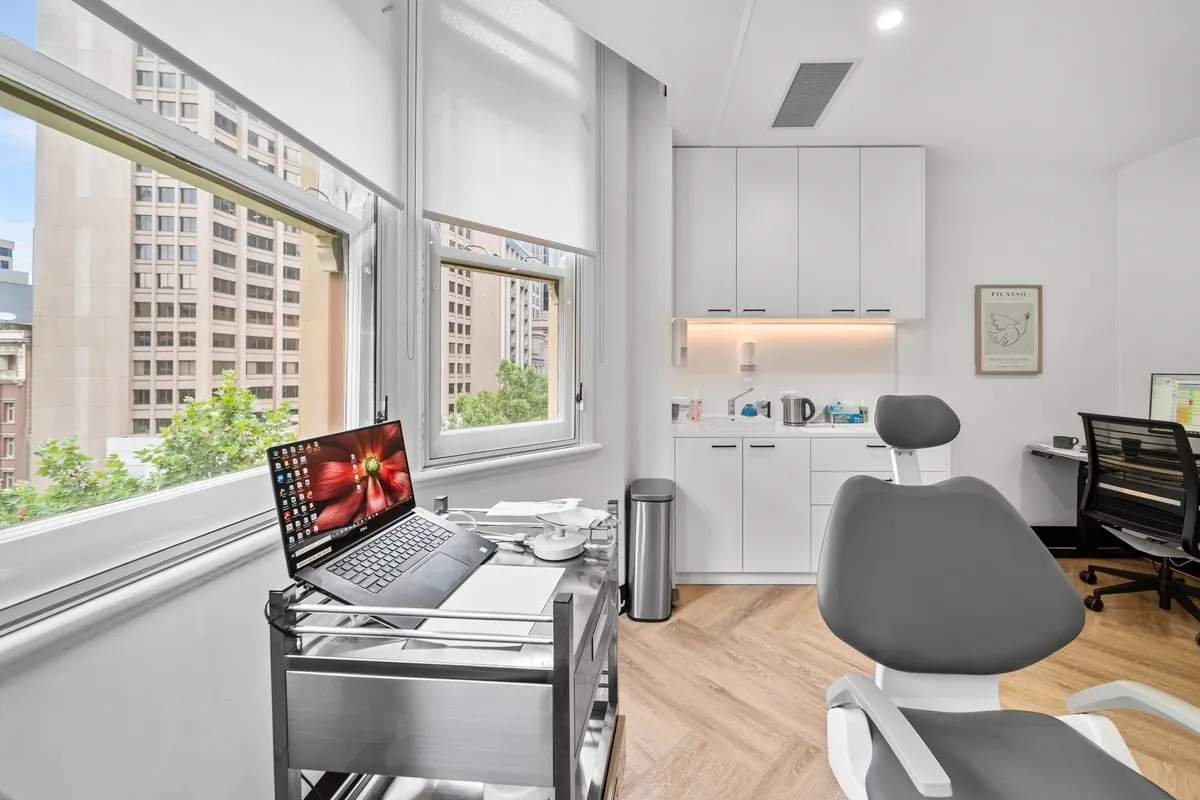 Dental surgery with treatment chair and city outlook at the SleepWise Clinic dental clinic fitout, Melbourne.
