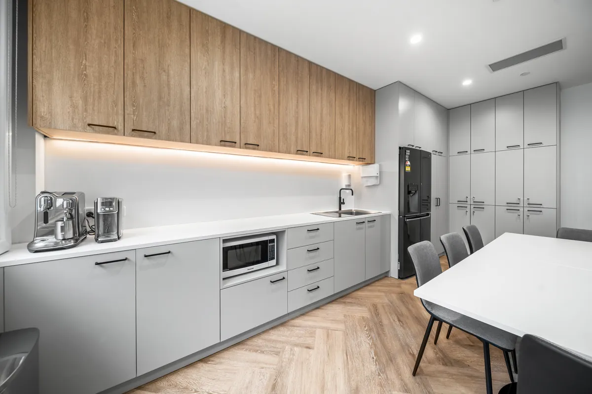 Kitchenette with coffee machines and timber joinery at the SleepWise Clinic dental clinic fitout, Melbourne.