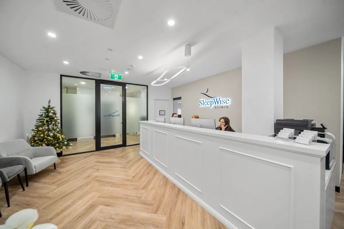 Reception desk and glass-partitioned entry at the SleepWise Clinic dental clinic fitout, Melbourne.