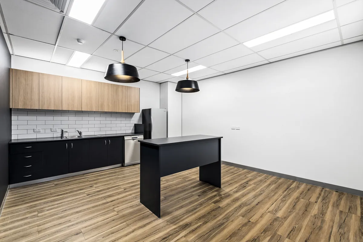 Spec suite kitchen and breakout with island bench and pendant lighting, Southbank