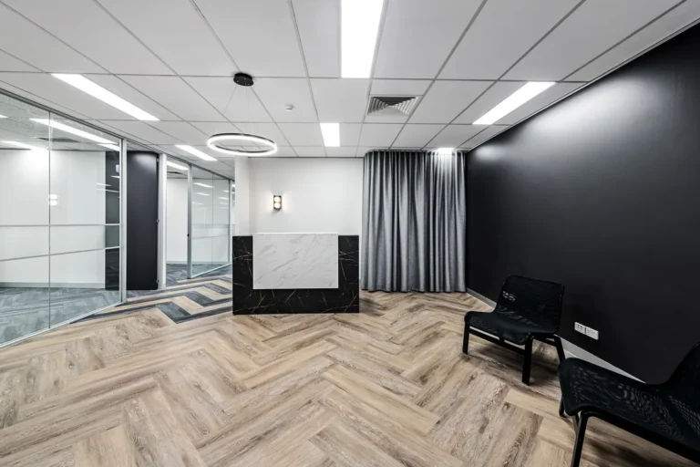 Spec suite reception with stone desk and black feature wall, Kings Business Park Southbank